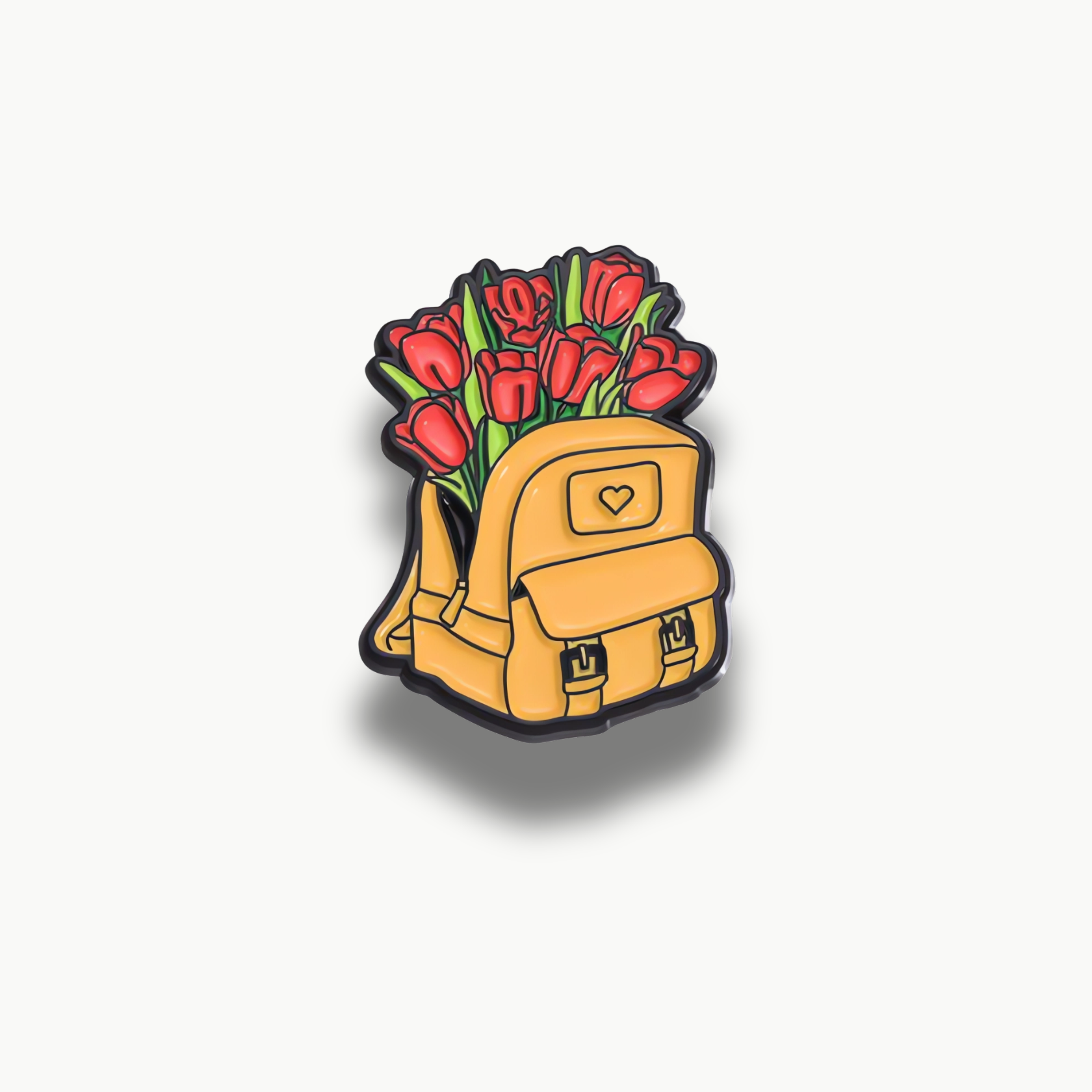 Brošňa s motívom žltého batohu s kyticou červených tulipánov.