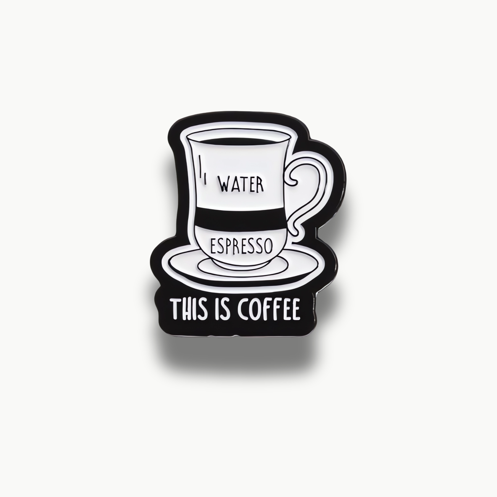 Čierno-biela brošňa zobrazujúca kávu s vrstvami vody a espressa a nápisom "THIS IS COFFEE".