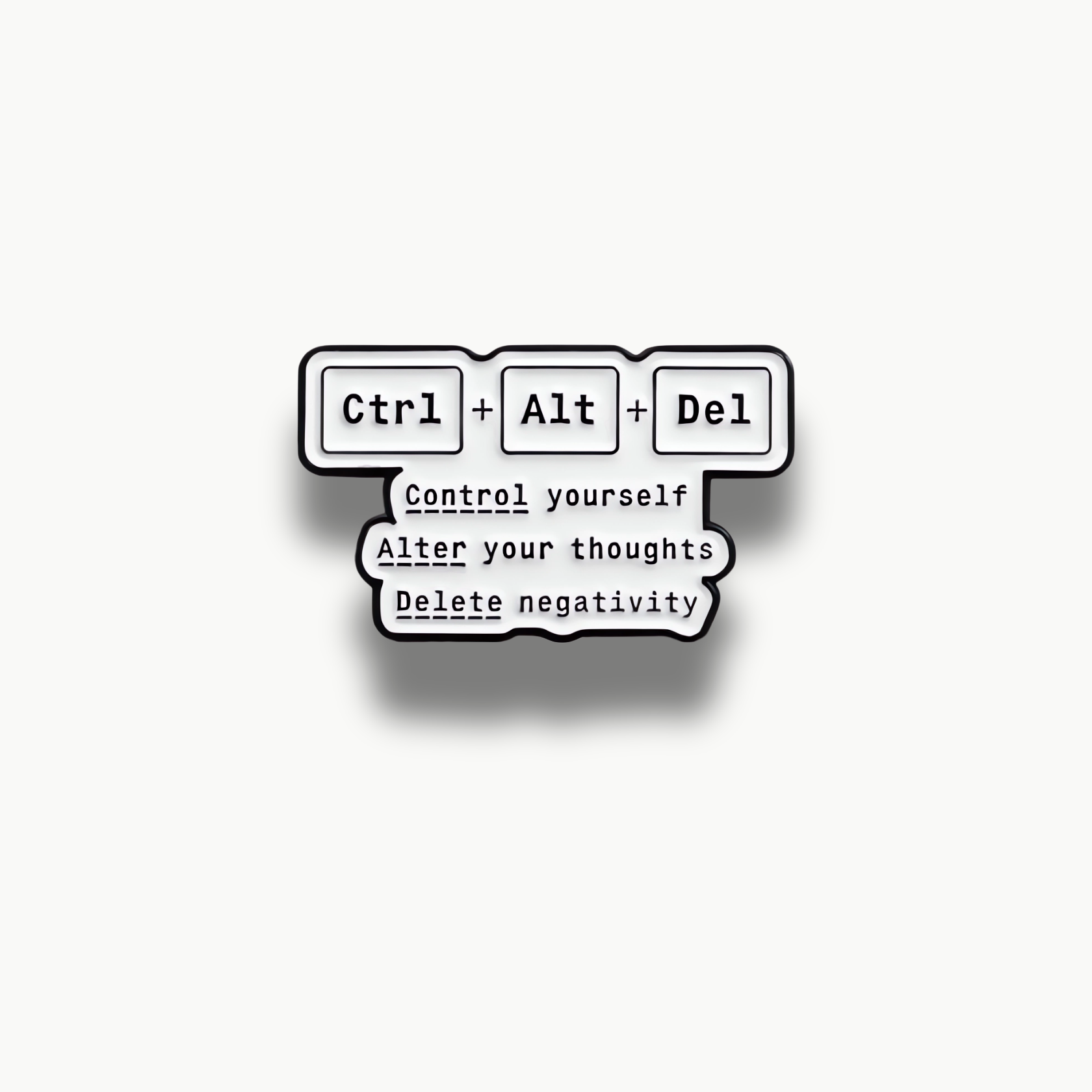 Biela smaltovaná brošňa s čiernymi klávesami Ctrl, Alt, Del a motivačným nápisom Control yourself, Alter your thoughts, Delete negativity.