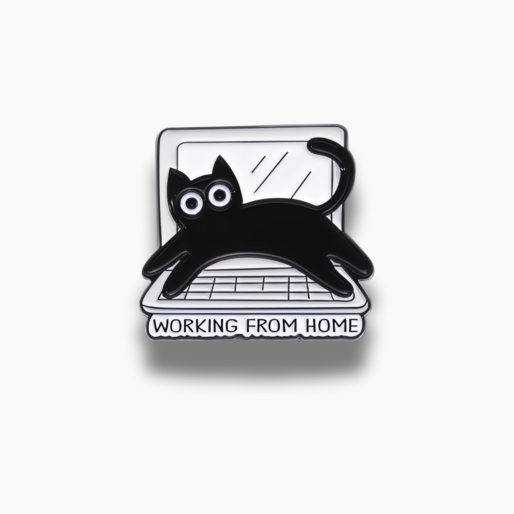 Čierna mačka s bielymi očami na otvorenom notebooku s textom Working From Home, smaltovaná brošňa.