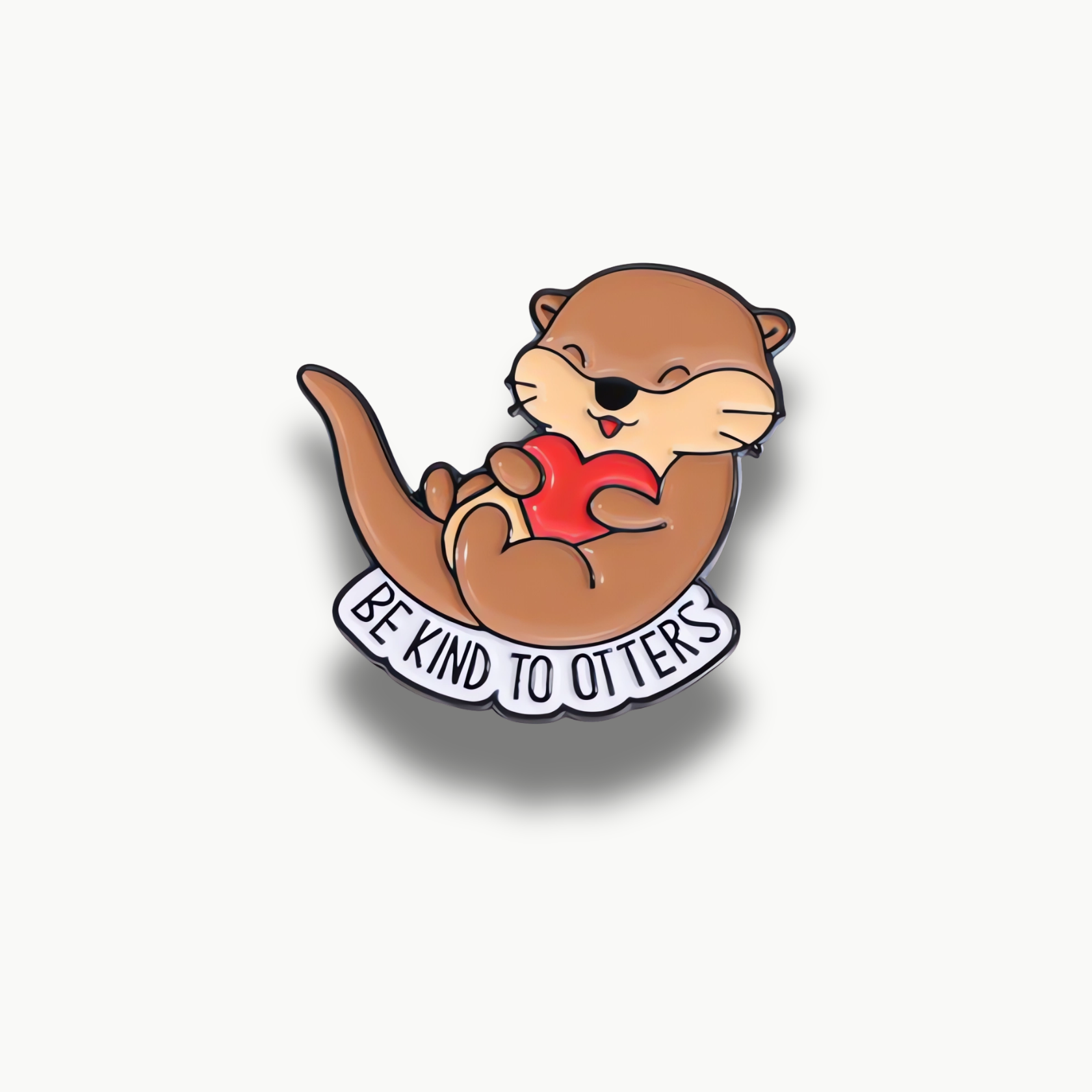 Smaltovaná brošňa zobrazujúca hnedú vydru s červeným srdcom a nápisom 'Be Kind To Otters'.